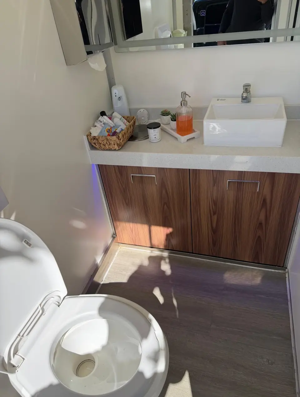 Restroom trailer vanity with sink, mirror and guest amenities