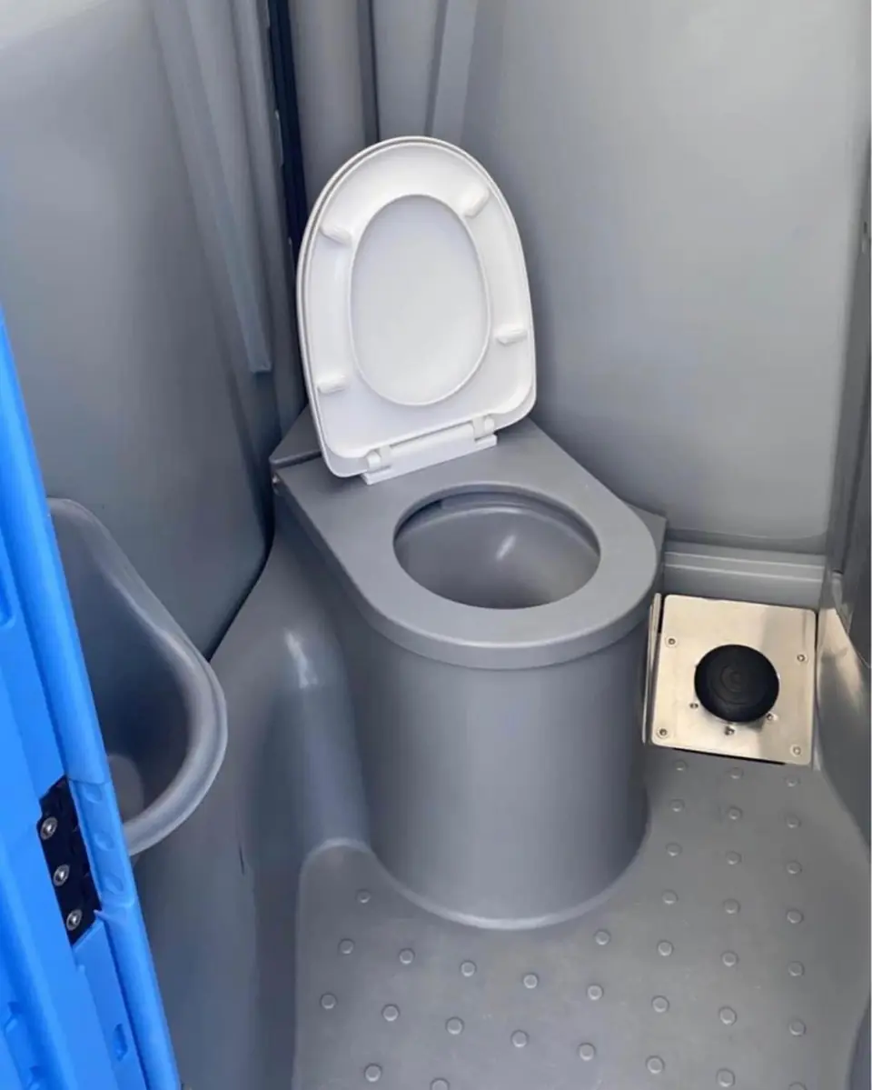 Toilet seat and toilet paper holder inside a standard porta potty
