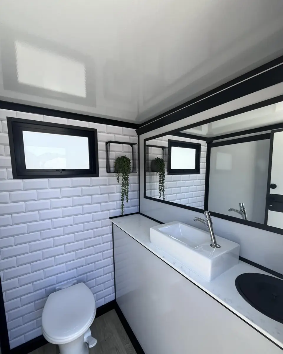 White tile walls inside a restroom trailer
