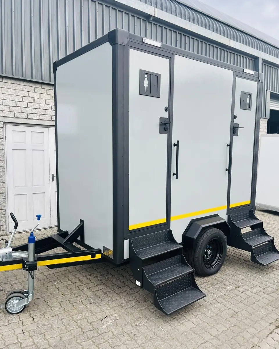 Two-stall restroom trailer with steps up to the doors